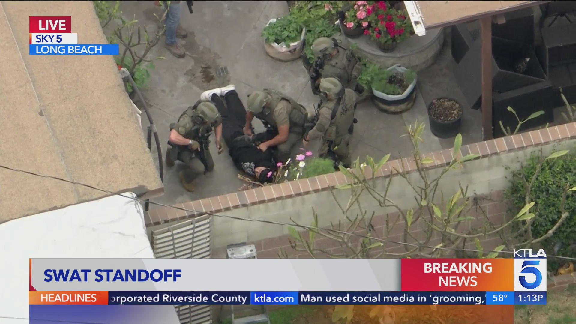 SWAT team engages in standoff with suspect in front of Long Beach home ...