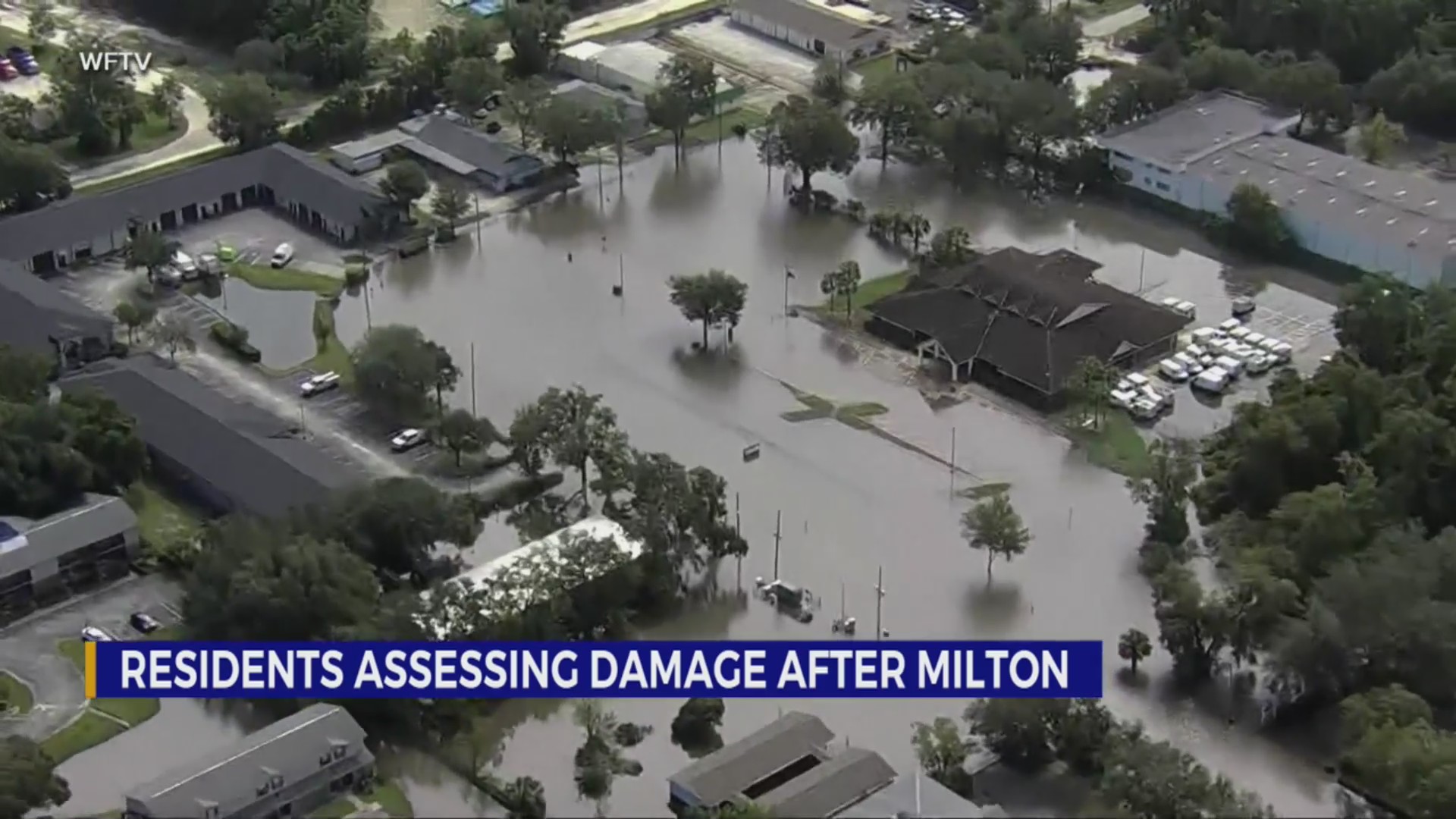 Residents slog through flooded streets, pick up debris after Milton ...